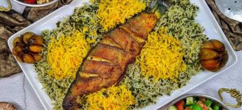 طرز تهیه سبزی پلو با ماهی قزل آلا به روش مجلسی؛ برنج سبز و خوش عطر با ماهی طلایی و برشته